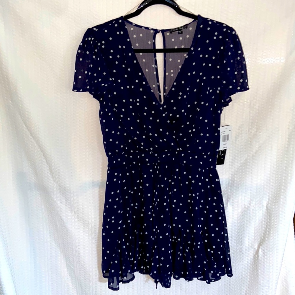 Navy and white polka dot patterned romper. From trixxi clothing company.
